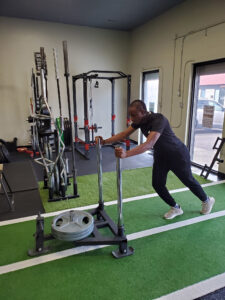 personal trainer using prowler sled
